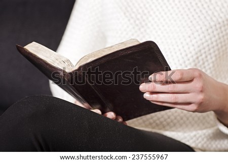 Woman sits and read the bible