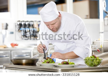 Chef prepares steak dish at gourmet restaurant