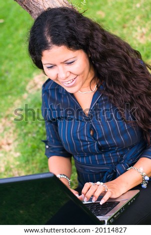 lady latina with laptop outdoors
