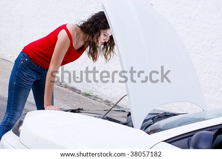 woman repairing car failure outside