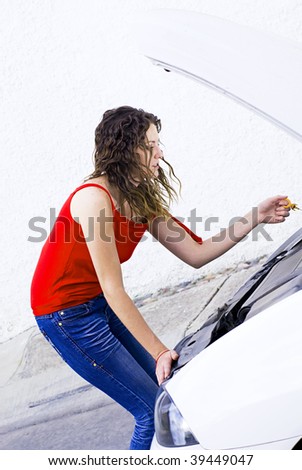 woman fixing car