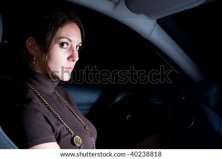 Alone woman waiting in car at night