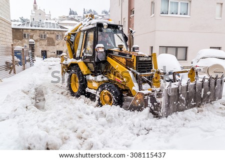 METKOVIC, CROATIA - FEBRUARY 4: Excavator cleans the streets of large amounts of snow in Metkovic, Croatia on February 4, 2012.