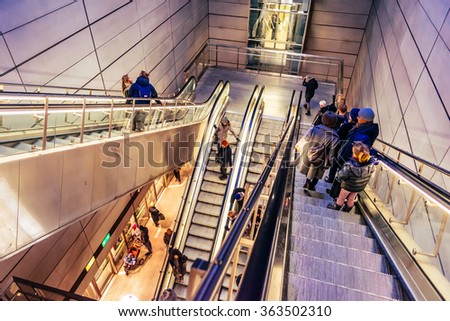 COPENHAGEN, DENMARK - JANUARY 3, 2015: People use escalators in Copenhagen, Denmark on their way down to the train station.