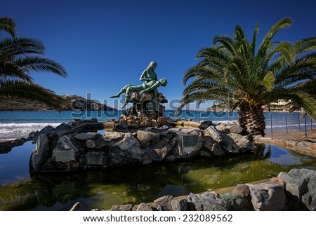 Bronze sculpture of a mermaid rescuing a sailor, in Syros island, Greece