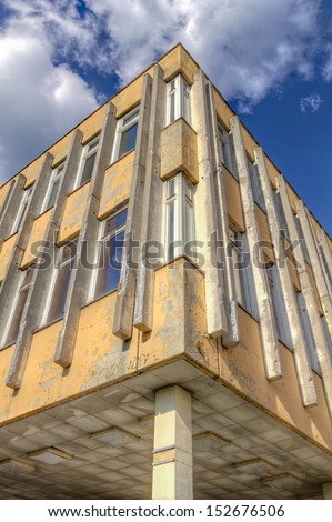 Run-down building with blue sky and clouds HDR