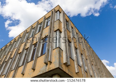 Run-down building with blue sky and clouds