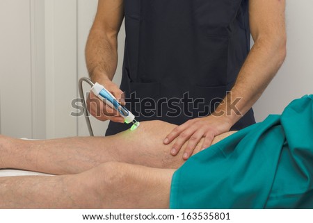 Laser Therapy on a knee of an old patient