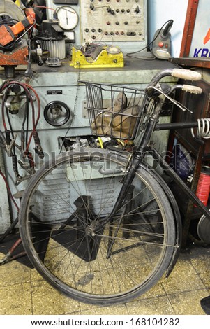 Old electro-mechanic tool in a workshop and grunge bycicle