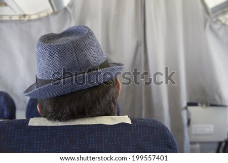 Aircraft cabin and passenger with hat
