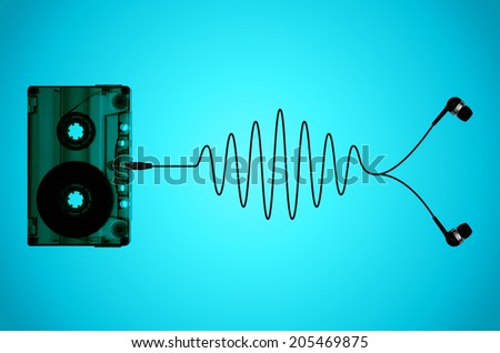 A cassette tape on a light blue back-lit background with tape coming out of the cassette to form a sound wave ending in a pair of ear-bud headphones.