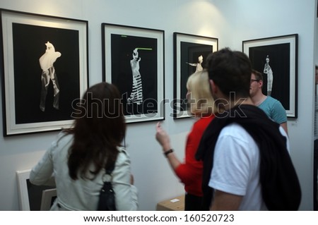LONDON, UK - OCTOBER 20,2013: Art enthusiasts view the artwork during Moniker Art Fair (and its partner The Other Art Fair) at The Old Truman Brewery in Brick Lane.