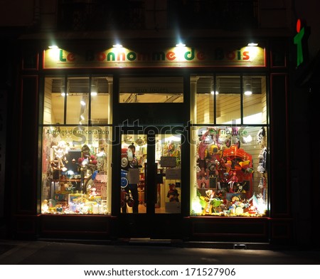 PARIS, FRANCE - CIRCA DECEMBER 2013: Local toy store stay open at night during the Christmas period in Paris