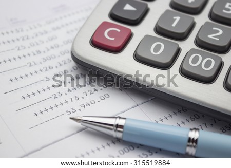 Calculator and pen on bank account passbook, selective focus