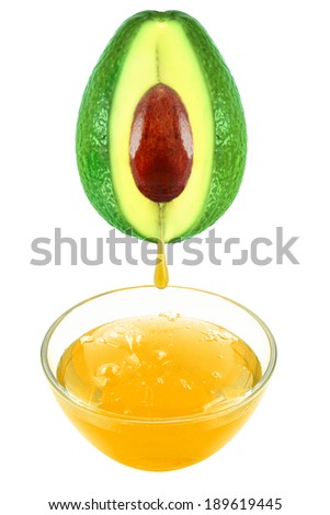 Fresh avocado oil flowing from avocado into the glass