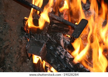 branding irons in campfire