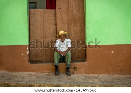HAVANA - FEBRUARY 1: Old man rests in shadowed area February 1, 2013 in Havana, Cuba. Average temperature in winter exceeds 30 degrees Celsius, elder people have to rest a lot during the day.