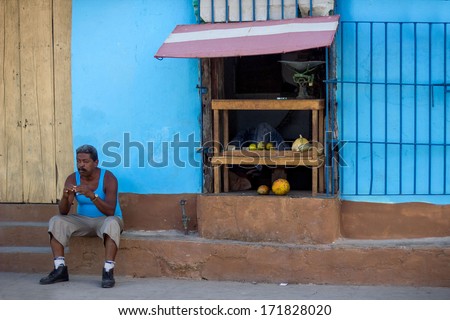 TRINIDAD - FEBRUARY 1: Old man rests in shadowed area February 1, 2013 in Trinidad, Cuba. Average temperature in winter exceeds 30 degrees Celsius, elder people have to rest a lot during the day.