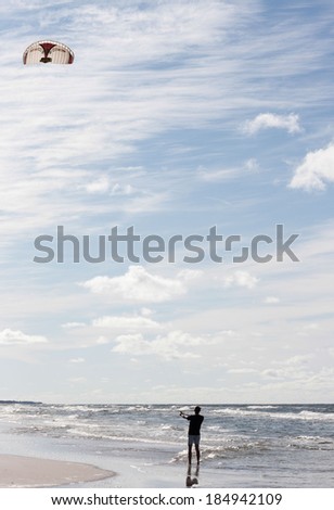 A kite surfer on a sea shore