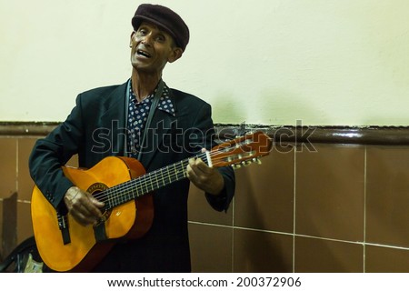 HAVANA - FEBRUARY 2: Old man plays the guitar February 2, 2013 in Havana, Cuba. Cuban music is an attraction for the over 2 million tourists who go to Cuba each year.