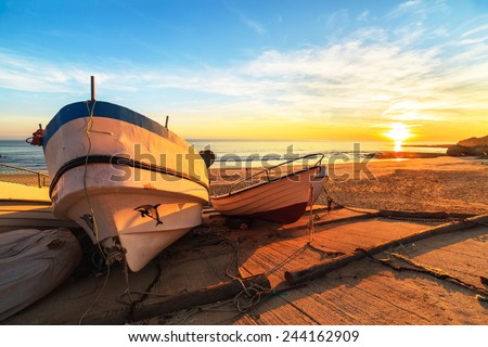 Boats in warm sunset light on the Fisherman\'s Beach (Praia dos Pescadores) in Albufeira, Portugal