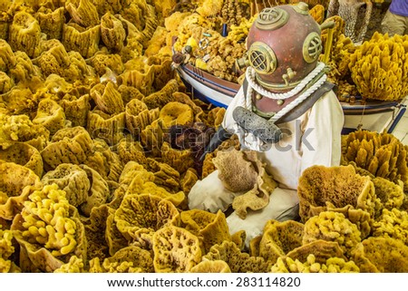 A vintage diving suit with helmet with natural sponges in the background, Greece