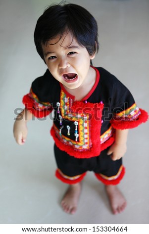 a boy in hill tribe dress.Hill tribe dress have no copyright. It is as well as their culture. Does anyone own.It can be easily purchased in the market in Chiang Mai Thailand.