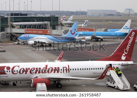 AMSTERDAM, THE NETHERLANDS - Maart 15, 2015 : Overview of airplanes parked at the gate at Schiphol airport. In the foreground of a plane from Corendo  On maart 15 , 2015 in Amsterdam, Holland.