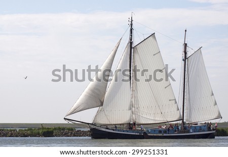 ENKHUIZEN, THE NETHERLANDS - JULY 18,2015: Vintage traditional  wooden sailing ship under sail leaving the port of enkhuizen with sunny weather on july 18 , 2015 in Enkhuizen, Holland.