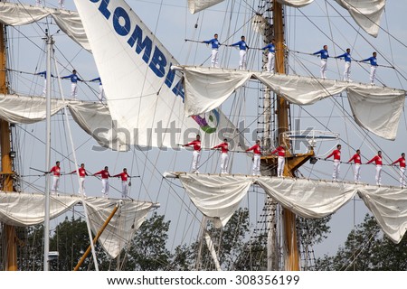Port of Amsterdam, Noord-Holland/Netherlands - August 19-08-2015 :  Sailors on the masts of the tall ship Arc Gloria from Colombia during sail 2015 ,on August 19, 2015 Amsterdam , Holland.