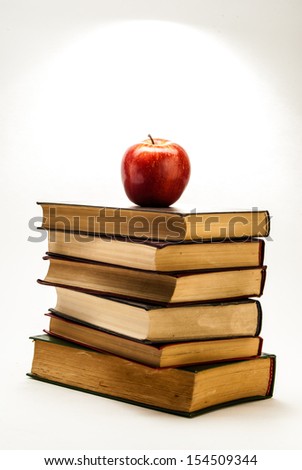 Stack of Old Books With an Apple on Top isolated on white