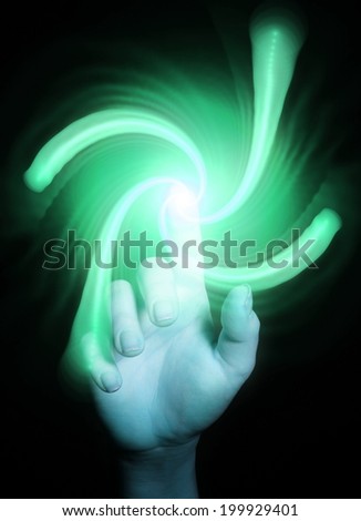 Hand pointing with  shiny colorful spiral on black background, as a concept metaphor of technology, science, and human feelings