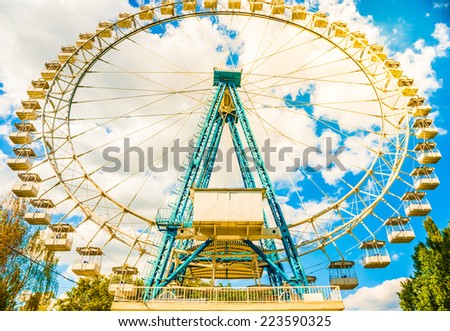 White ferris wheel on blue cloudy sky