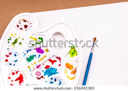 Art palette with blank paper and brush for watercolor drawing