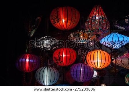 Night lanterns in old Hoi An town in Vietnam. Background of ancient eastern culture. Multiple colors and bright lights.