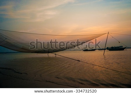 Calm scene of fishing net against purple sunset. Nautical background.