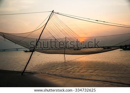 Calm scene of fishing net against purple sunset. Nautical background.
