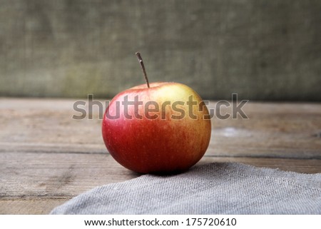 fresh apple on linen tablecloth on wooden table