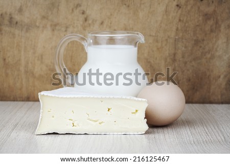 camembert cheese slice, milk jug and egg, dairy products