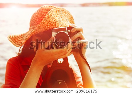 girl with vintage camera taking photo, filtered