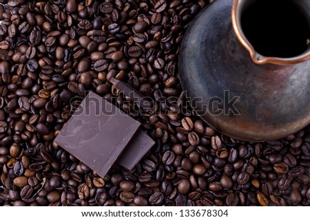 coffee beans, pieces of dark chocolate and coffee maker