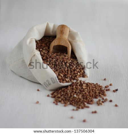 Buckwheat with wooden spoon in the cloth bag
