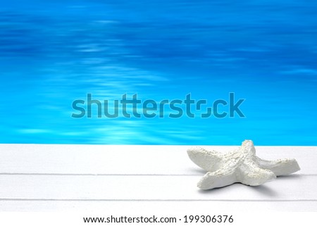 Starfish on white jetty / peir with sea / water background - summer time / spa, balneo, relax, wellness