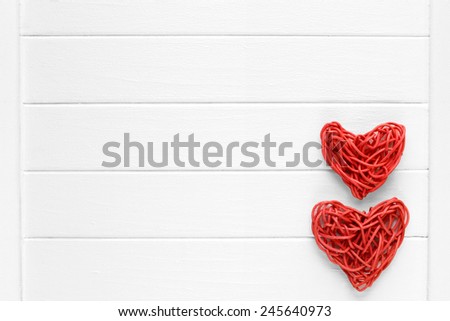 Couple of love red pedig rattan hearts on wooden light background - valentines - mothers day - fathers day - wedding invitation - card - space for text