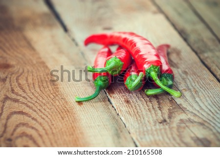Very spicy peppers, chili, cayenne, jalapeno, peperoncino on wooden background