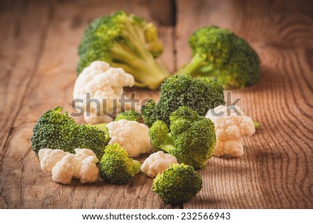 Delicious broccoli and cauliflower has a wooden rustic table