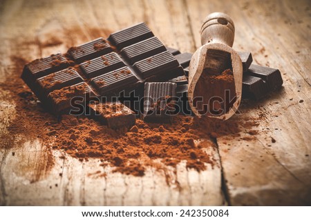 Noble dark chocolate on a wooden table in vintage style.