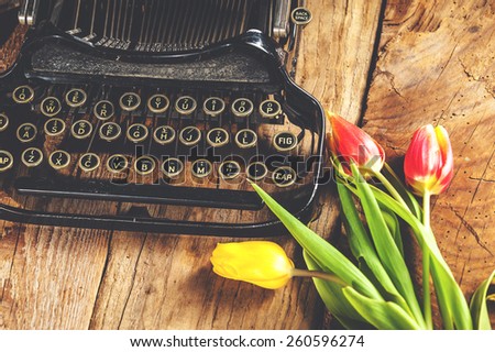 Flowers at the typewriter, writing a romantic letter.