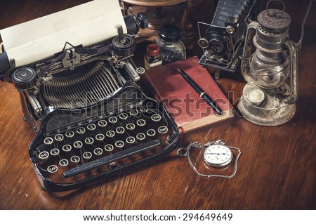 Traditional and old way of writing messages and taking photos, typewriter, camera, watch, pen, Vintage lamp on the desk
