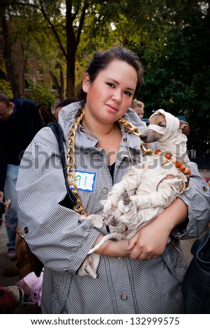 NEW YORK, NY - OCTOBER 24, 2010: An unidentified woman and her dog, dressed as a mummy, attend the Tompkins Square Halloween Dog Parade. The event included a costume contest.